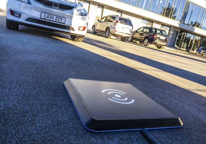 Close-up of wireless charger on road.